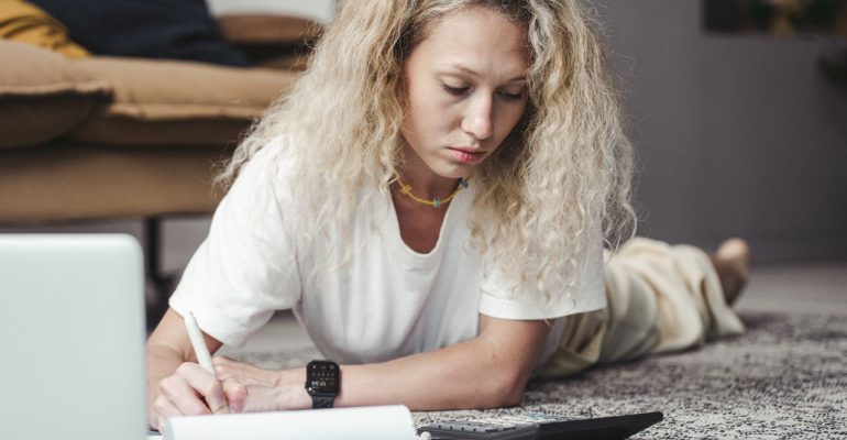 Person reviewing monthly finances after payday during debt review process
