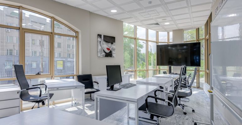 Professional cleaner providing cleaning services in a business office