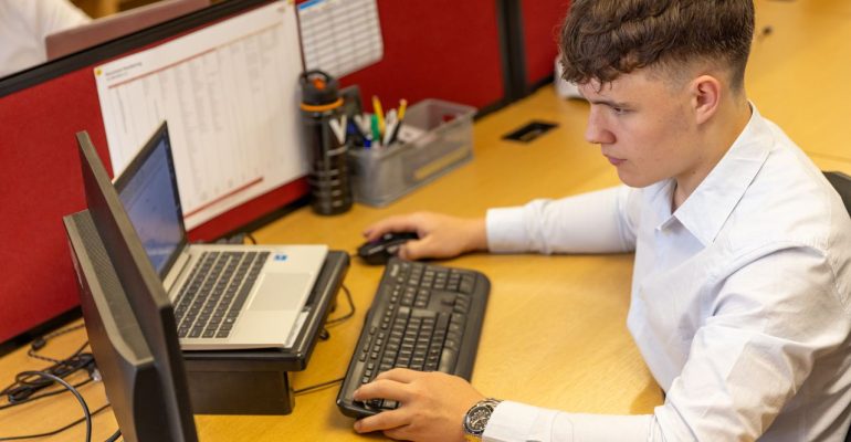 Employee organising business information on a computer